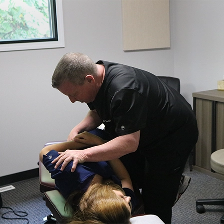 Chiropractor Lansing MI Daniel Dail Adjusting Patient